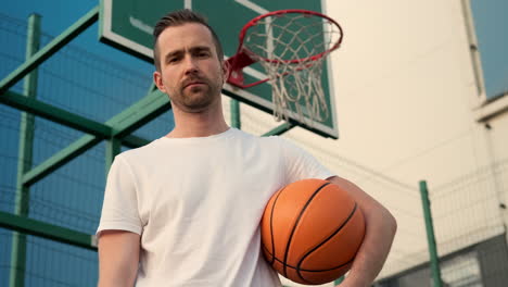 man holding basketball on a court