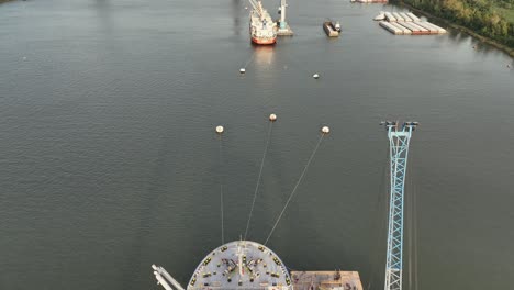 working ships along the mississippi river near grain elevator