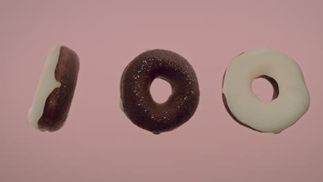 white glaze donuts on a light pink background