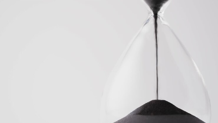 Video of hourglass with sand pouring, copy space on white background