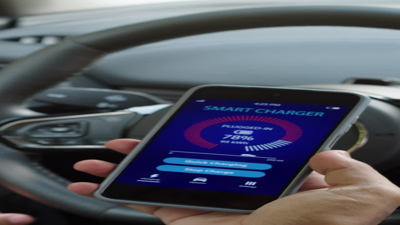 Vertical of Hands of Man Monitoring Charging Status on Smartphone App