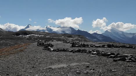 Drone-taking-off-from-top-rocky-mountain-with-beautiful-landscape-in-background