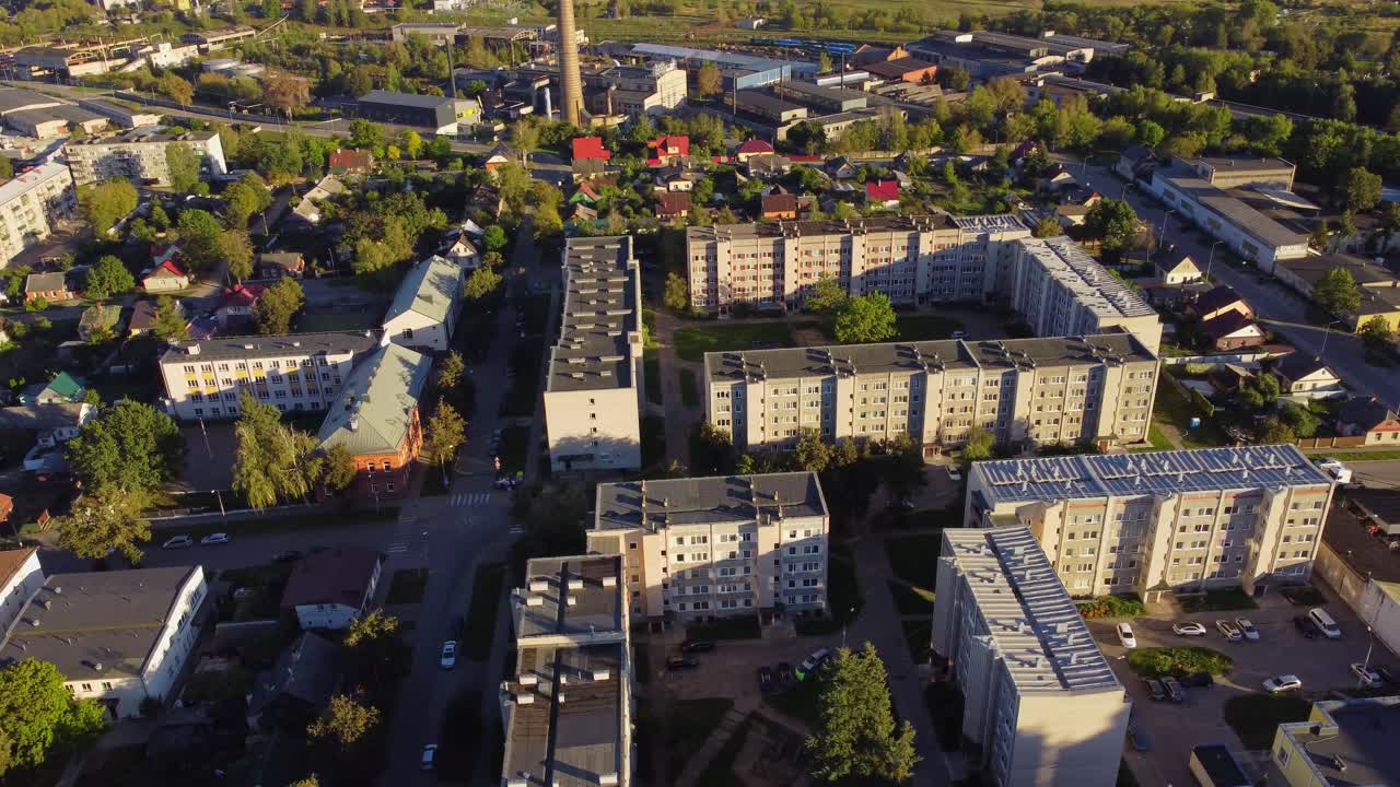 Aerial view of residential block buildings in urban neighborhood with green spaces