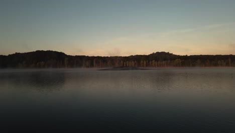 calm water. glass like.  mist rising over sunrise