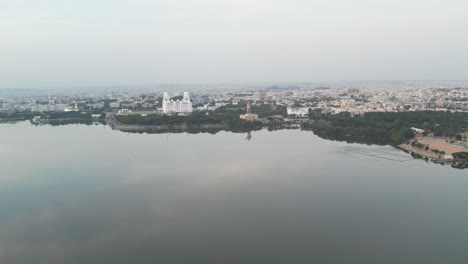 Aerial-view-of-the-Hussain-Sagar-Lake-in-Hyderabad,-the-Telangana-Secretariat,-and-the-Martyrs-Memorial,-which-is-home-to-the-world's-largest,-125-foot-tall-DR