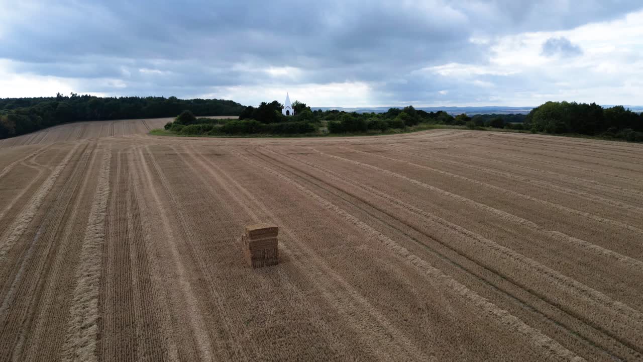 Farley mount hilltop monument time-lapse clouds passing across golden haystack Hampshire farmland