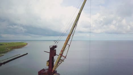 an old abandoned rusty crane in the seaport 02