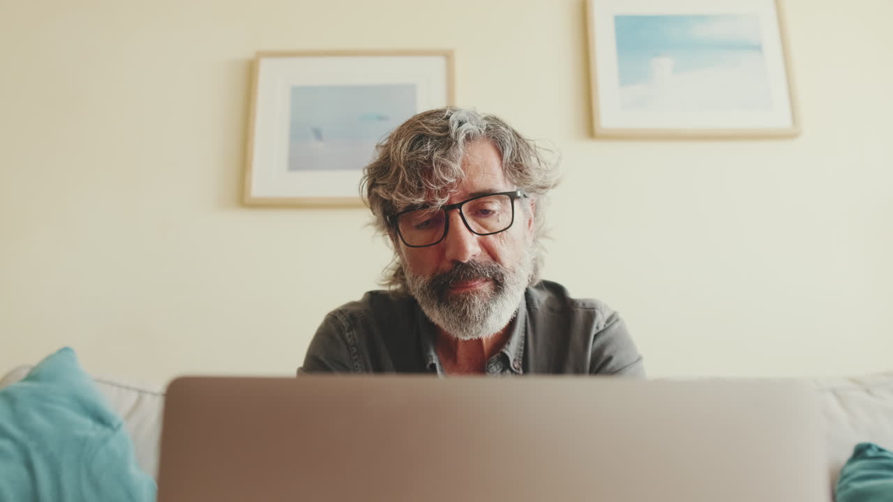 Man with laptop on couch