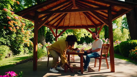 friends playing a game in a garden pavilion