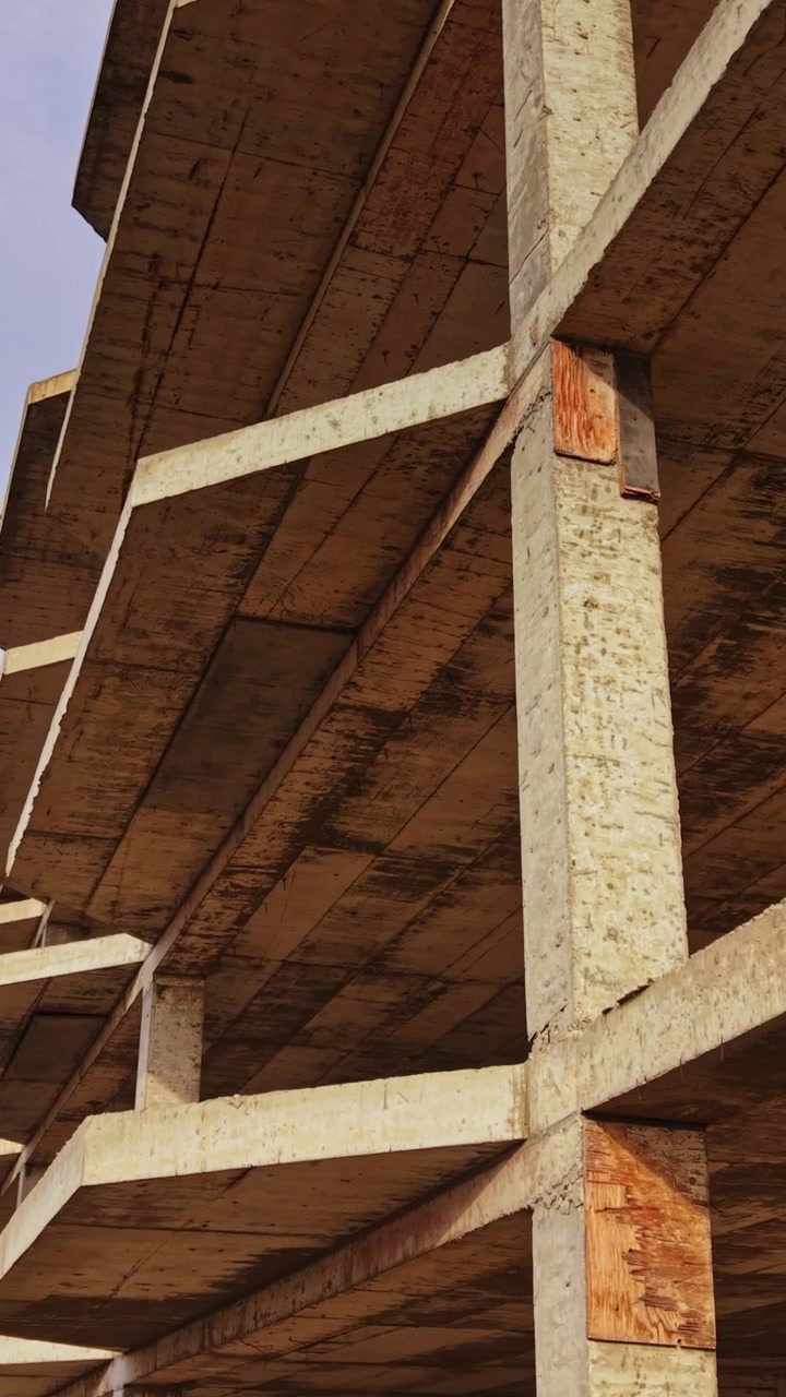 Building structure viewed from above showcases concrete details and sky