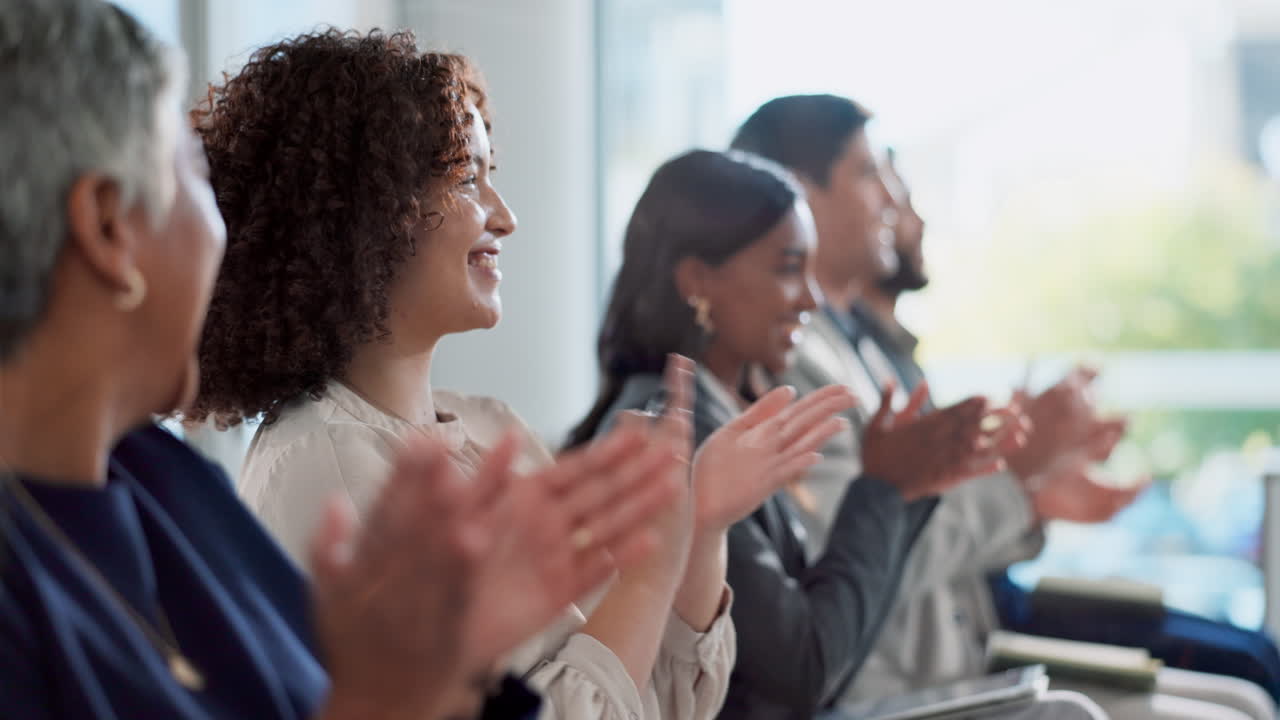 Group of people clapping at a conference
