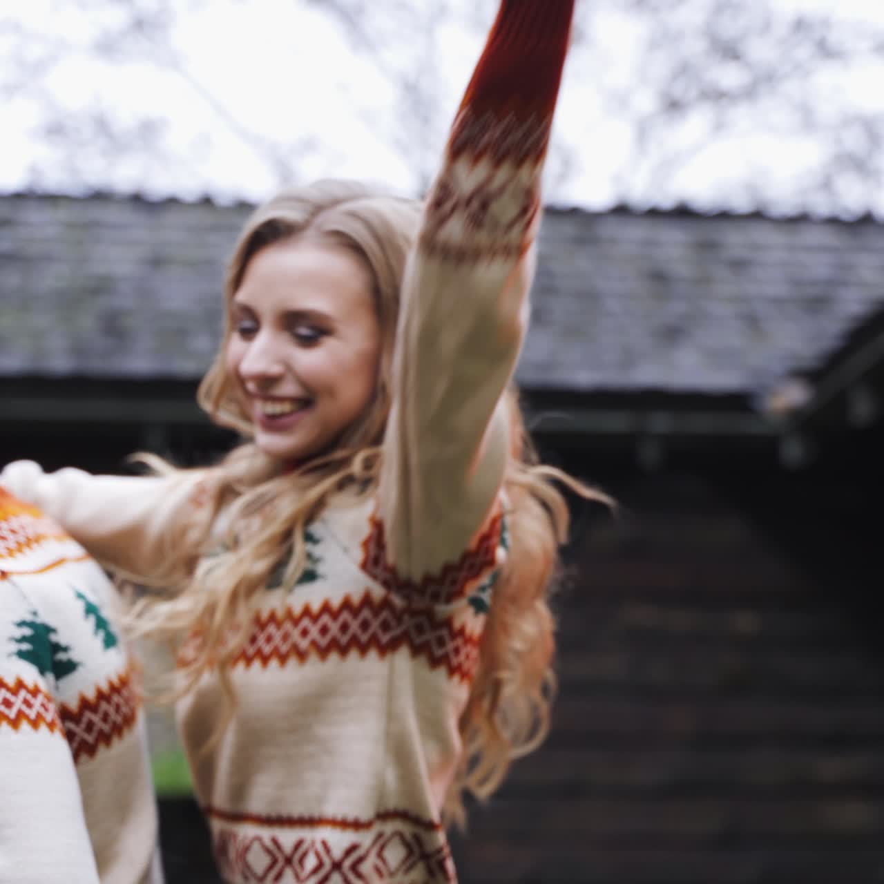 Happy couple having fun. Romantic couple in warm sweaters enjoying time together outdoors. Smiling girl on her boyfriends back. Close-up.