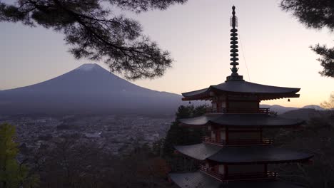 static shot of chureito pagoda at dusk with mount fuji in backdrop