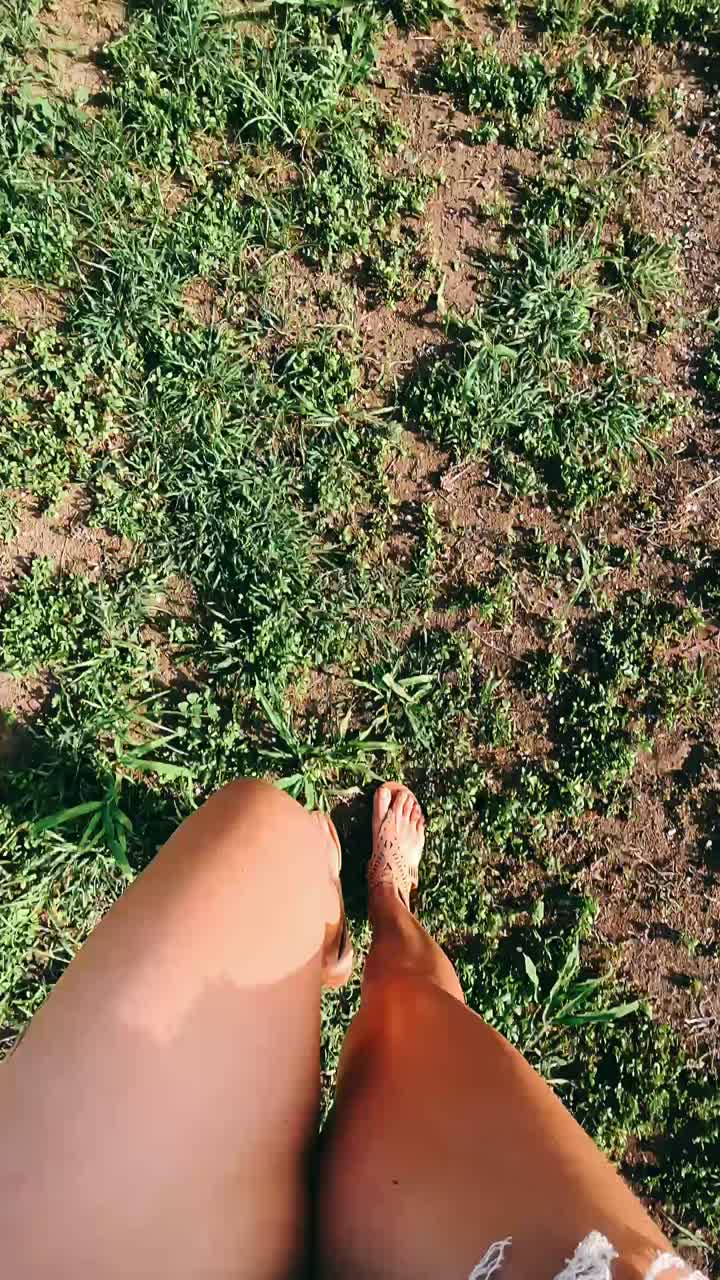 Woman Walking Through Grass