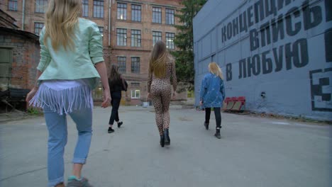 group of young women walking outdoors in a city