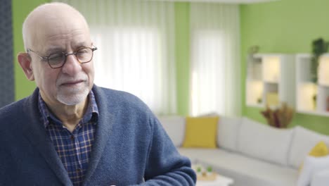 Happy-old-man-looking-at-himself-in-the-mirror-at-home.