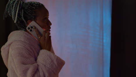 woman talking on phone in night-time