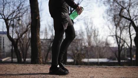 Male-legs-in-black-tight-compression-leggins-walking-in-park.-Sport-and-recreation.