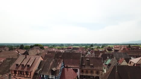 a stationary panning footage to the left while revealing the roofs of the houses and the whole village