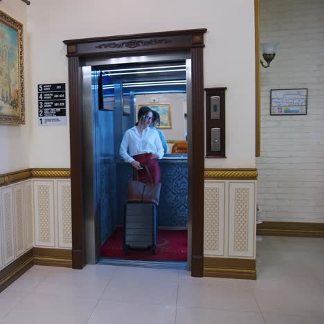 young businesswoman standing in elevator