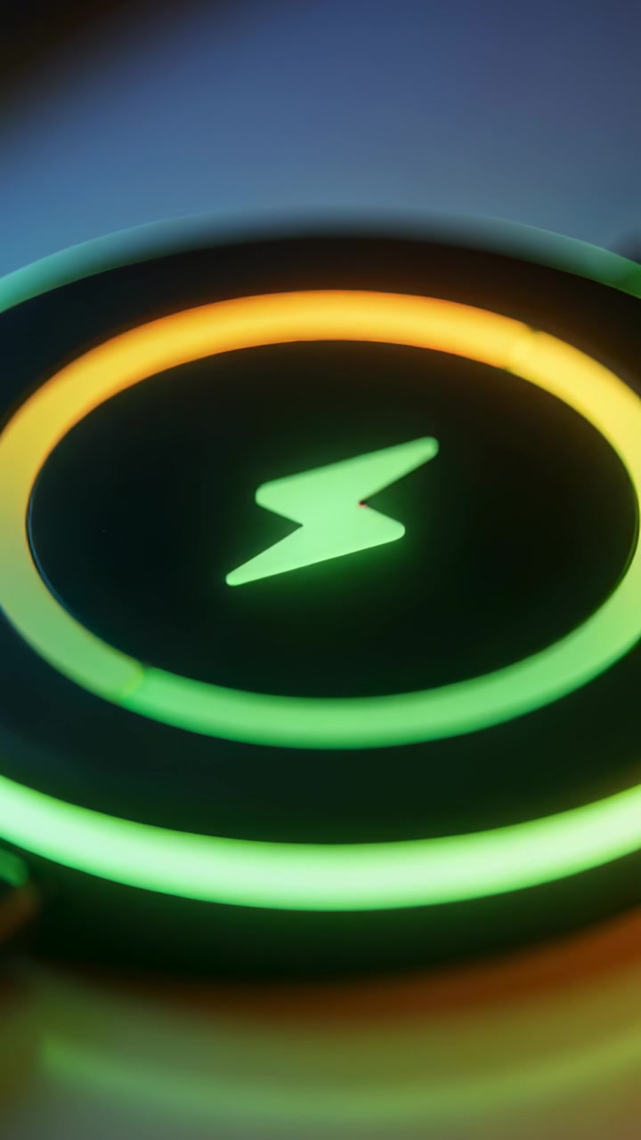 Vertical video: Powering pad with bolt, inner orange LED moving on shiny table showing charge