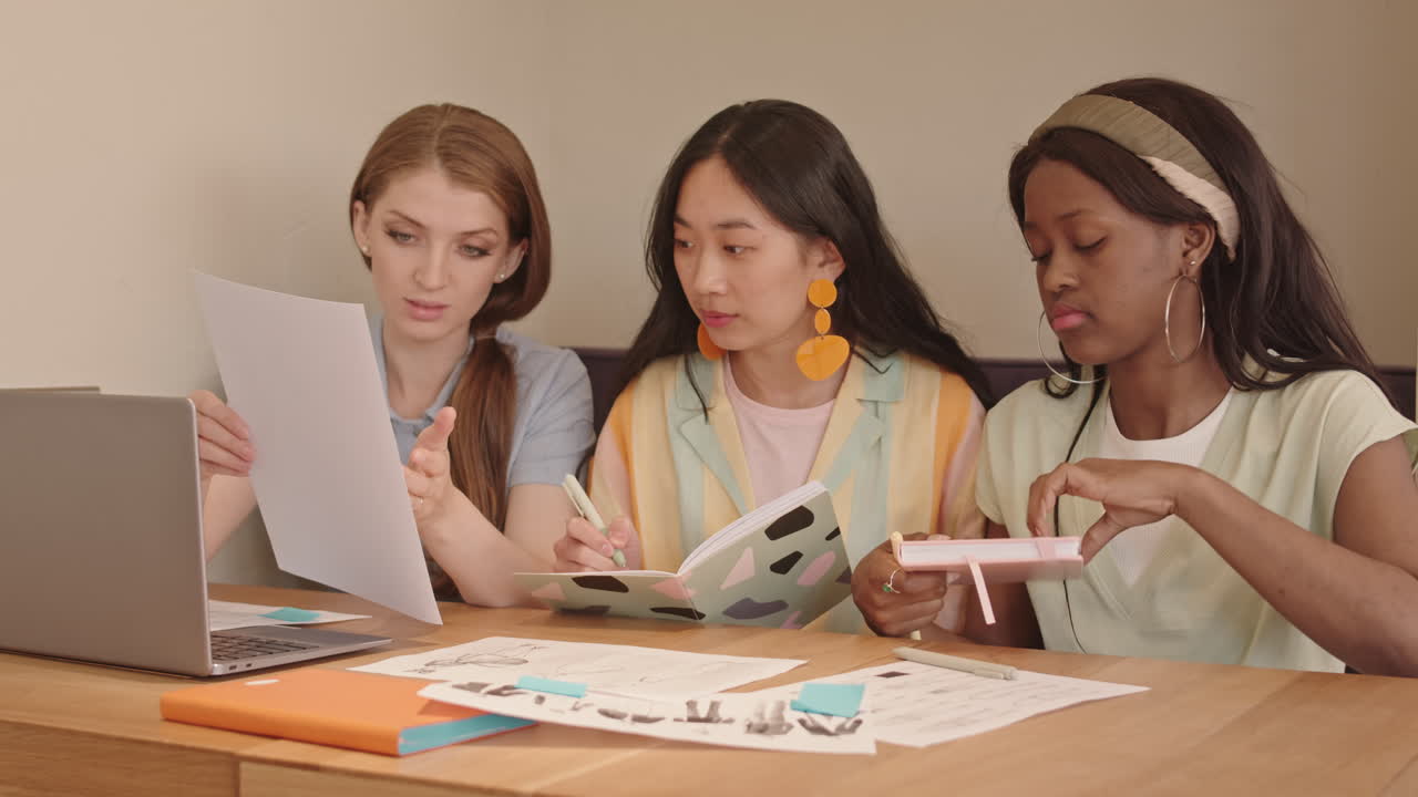 Female Designers Working on Fashion Sketches