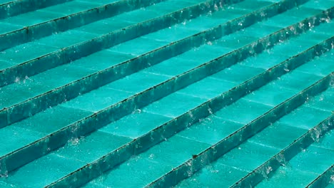 water cascading down a set of blue stairs