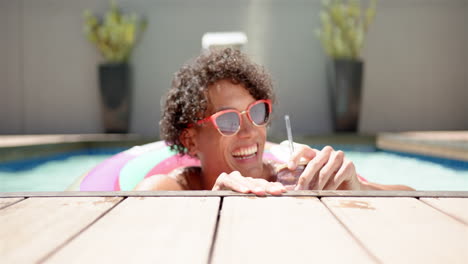 a young biracial man relaxes in a pool at home