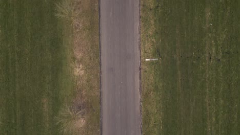 aerial view of a road through grassy fields