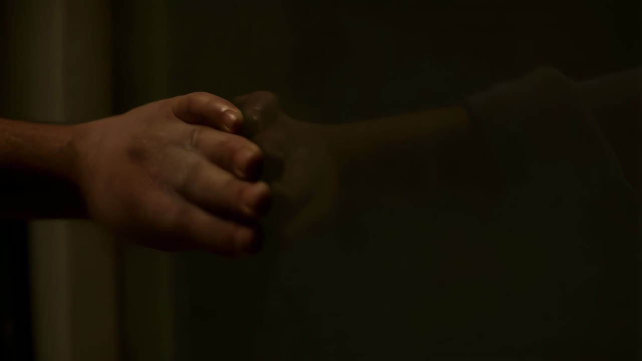 A Hand Touching a Reflective Surface