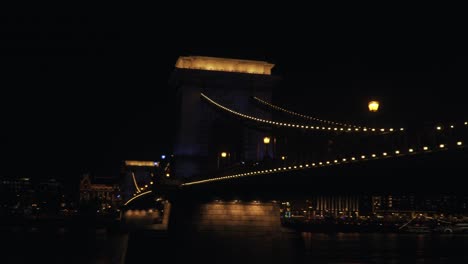 The Famous Chain Bridge In Budapest Surrounded With Lights Above The Danube River During Evening - Wide Shot