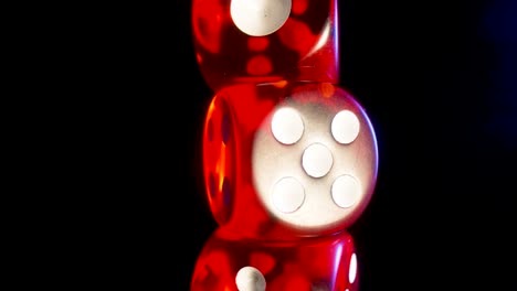 red dice stacked on black background
