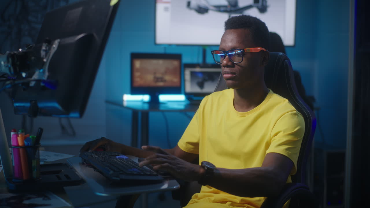Man working on a computer in a dark room