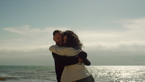 loving couple enjoying sea beach. happy people hugging together on sunny day.