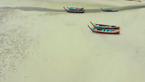 aerial view or top view of long-tailed boat is floating on the emerald sea