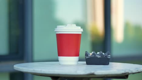 coffee and cigarette ashtray on an outdoor table