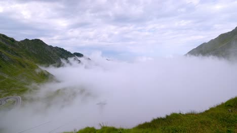 clouds moving over the transfagarasan mountain pass and cable cars in carpathian mountains, romania