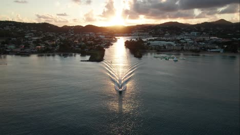 speedboat leaving rodney bay marina at sunset