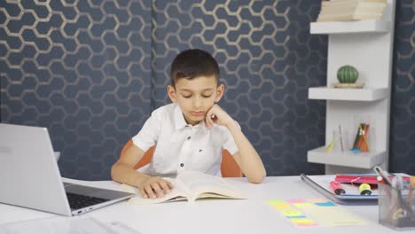 unhappy and sad boy is bored of reading.