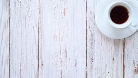 macarons and coffee on a light wooden table