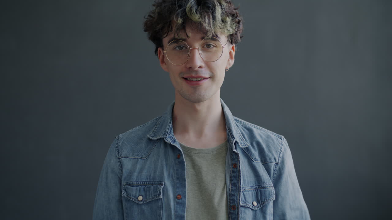 Smiling Young Man with Thumbs Up