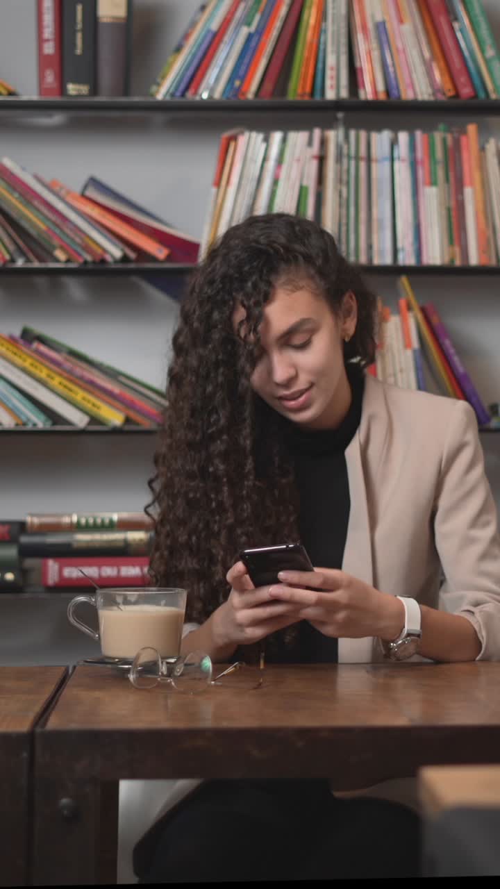 Woman using smartphone in a cafe