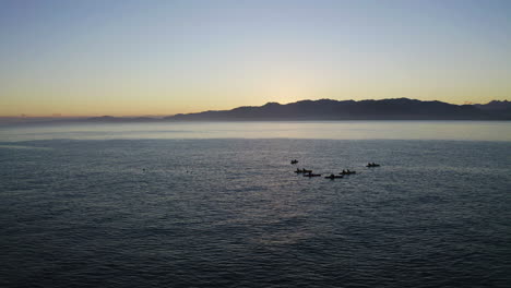 Kayaking-in-the-ocean-at-Kiakoura-New-Zealand-during-a-beautiful-sunset-along-the-coastline