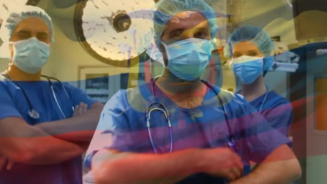 Animation-of-flag-of-ecuador-waving-over-surgeons-in-face-masks