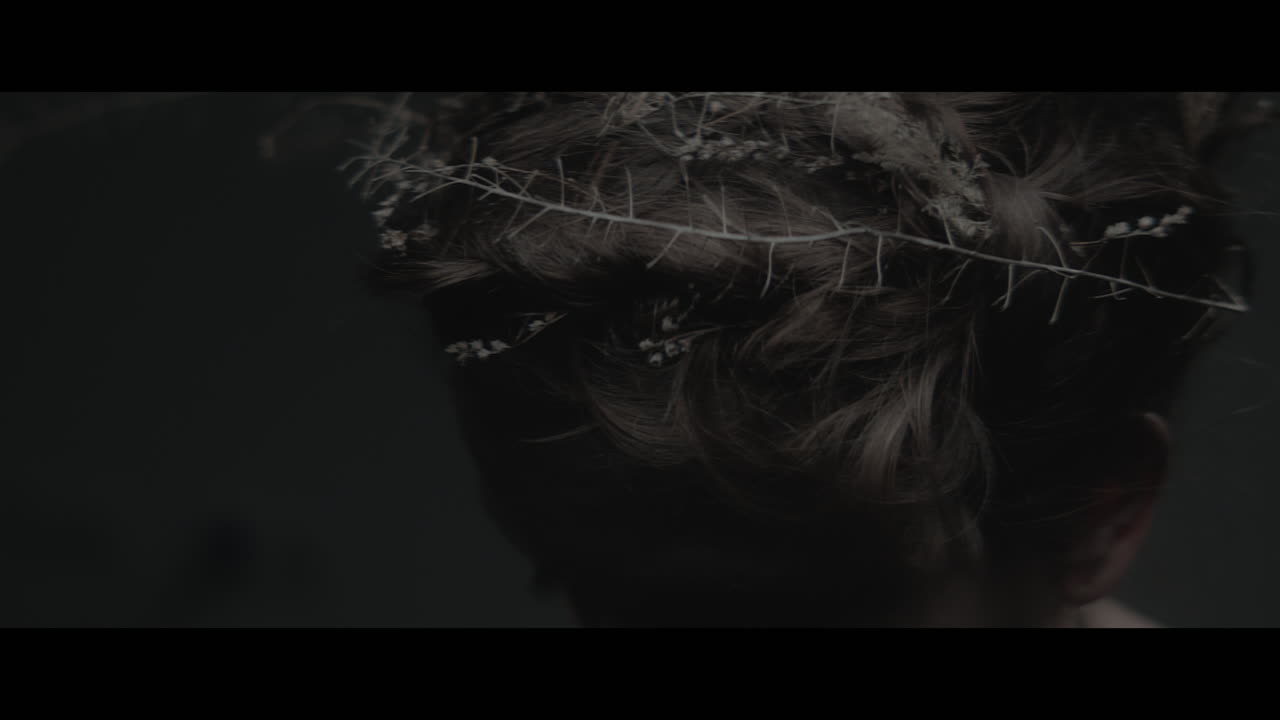 A woman dressed as mother nature shows her hair