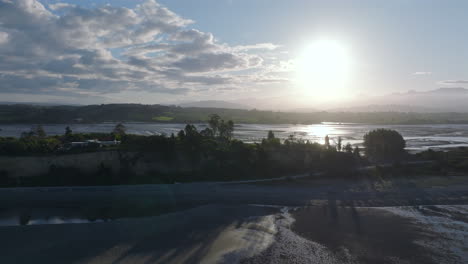 aerial drone shot of the sun late in the day over the tasman district coastline near motueka new zealand