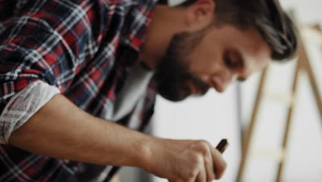 tilt up video of man painting raw boards