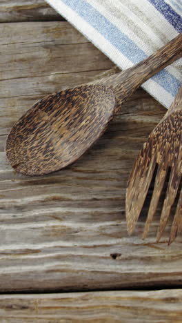 wooden spoon and fork with napkin on table