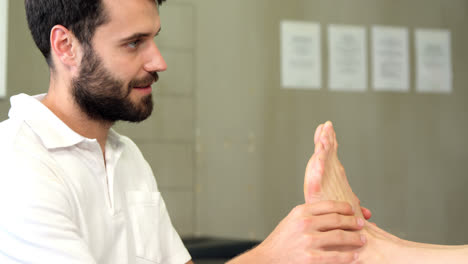 physiotherapist giving foot massage to a woman