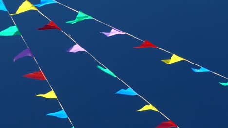 multicolored flags on the blue sky.